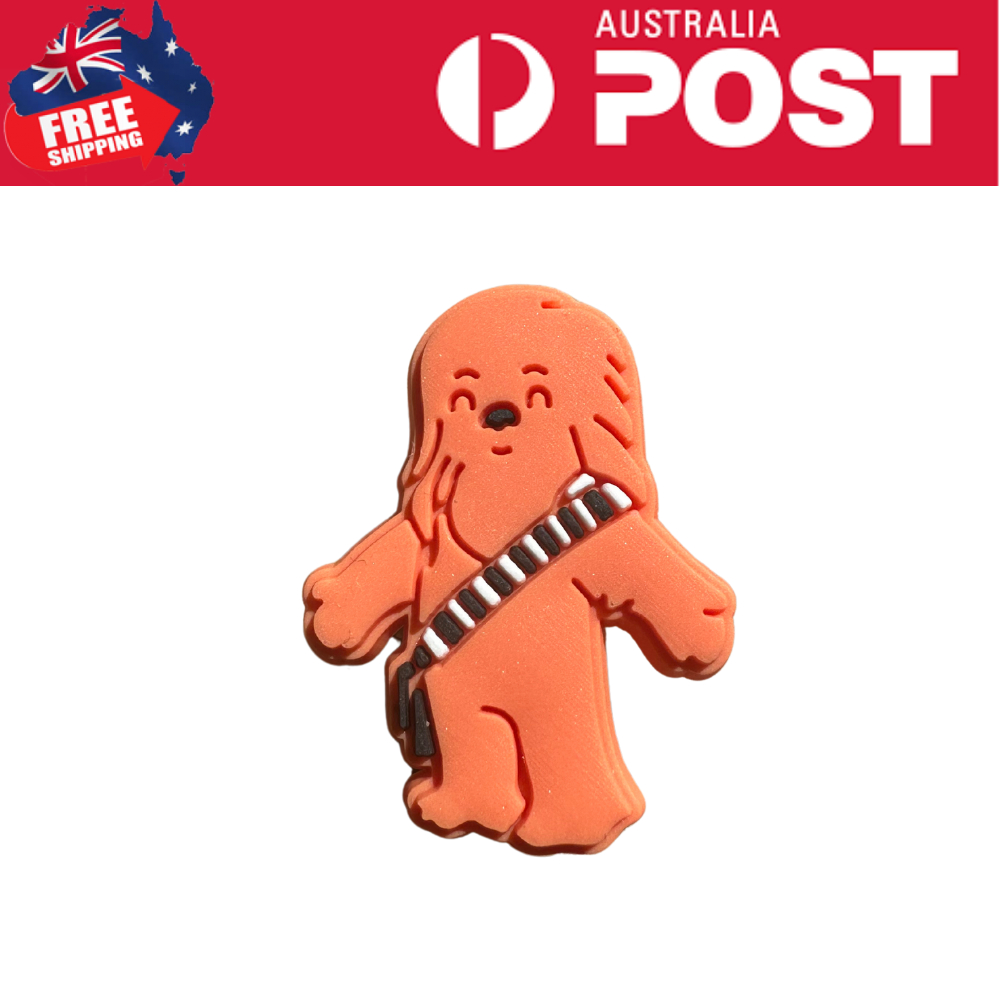 Smoothed orange dog-shaped rubber keychain with musical instrument design, cute and playful accessory for bags or keys.