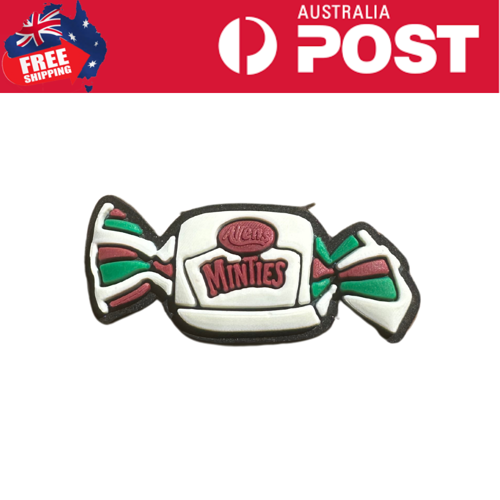 Colorful Minsties candy shaped cookie with festive green, red, and white icing details.
