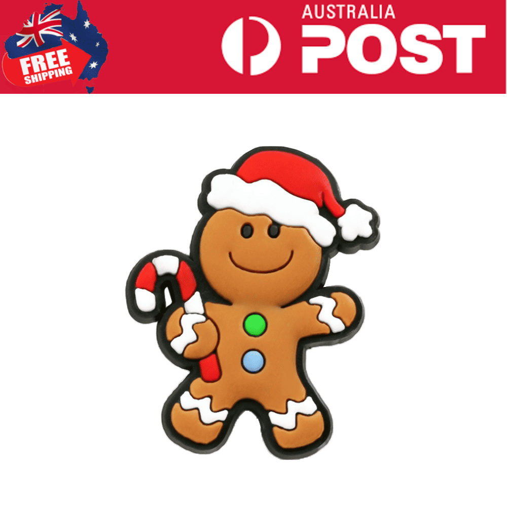 Colorful gingerbread man cookie decorated with Christmas holiday themes, wearing a Santa hat and holding a candy cane.