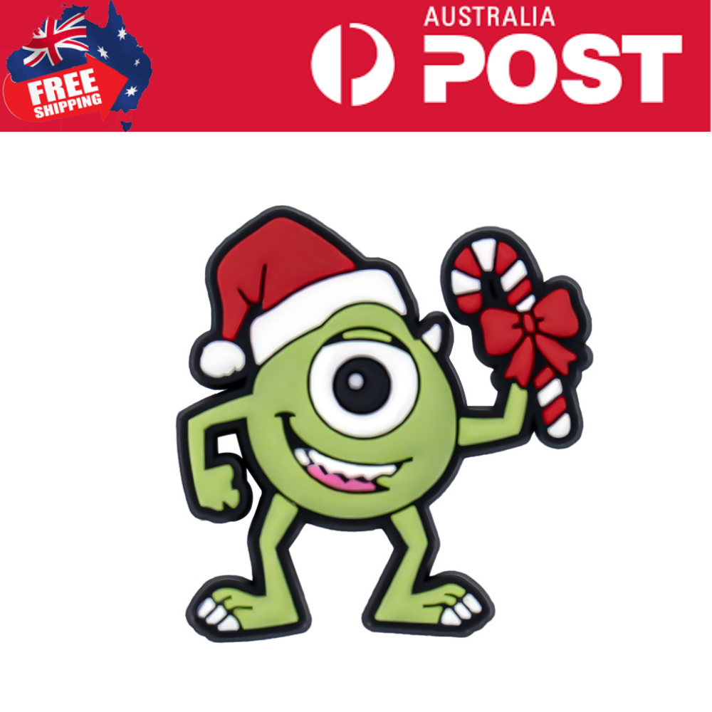Cute green cartoon monster wearing a Santa hat and holding a candy cane with a red bow, perfect as holiday jewelry or accessories.