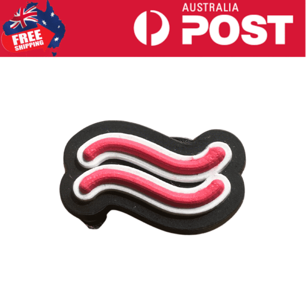 Bacon-shaped rubber keychain with red, white, and black colors for kitchen or gift accessories.